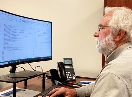 Mark Mason sits at his office desk as he works on